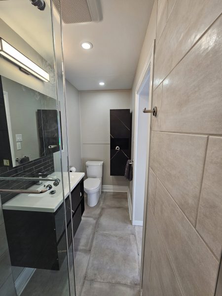 The renovated washroom now boasts a stunning new shower with state-of-the-art fixtures and a streamlined design. The space has been carefully crafted to provide both visual appeal and enhanced functionality, making it a luxurious retreat for daily use. The transformation not only resolved the previous issues but also elevated the overall style of the main floor washroom, reflecting our commitment to quality and diligence. The result is a beautifully modern washroom that perfectly aligns with the clients' vision and enhances their home experience.