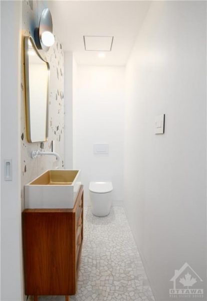 The renovation included the creation of two new washrooms, featuring contemporary fixtures and finishes, and a custom-designed kitchen that perfectly blends functionality with style.